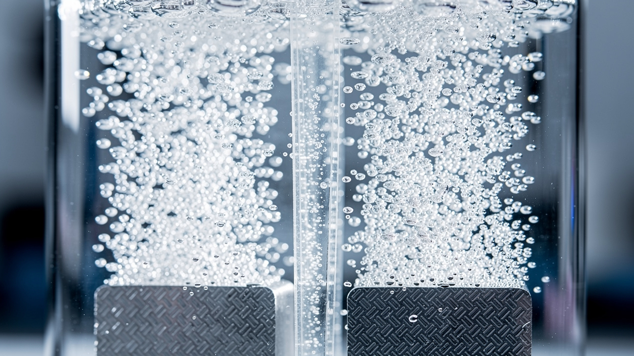 Closeup of hydrogen water electrolysis inside a Proton Exchange Membrane chamber - the dual-chamber technology that separates hydrogen from oxygen and ozone byproducts