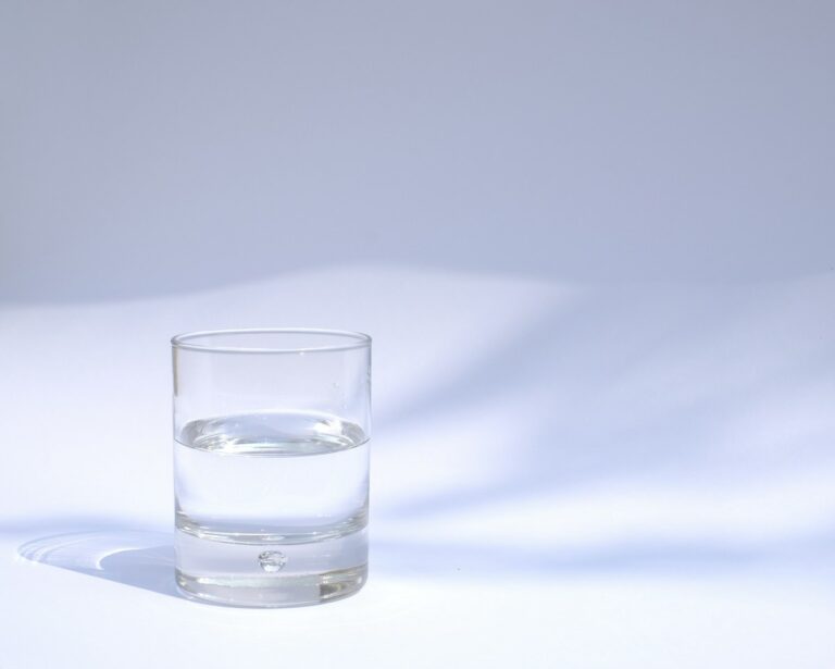 Clear drinking glass of water on a bright table